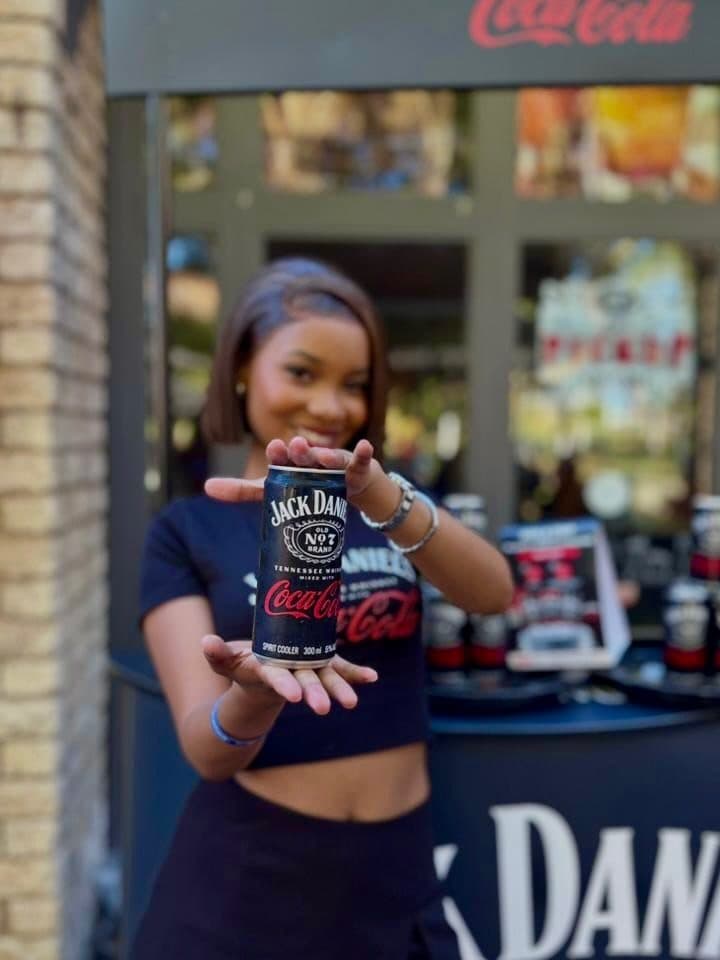 Brand ambassador presenting a Jack Daniel's and Coca-Cola can