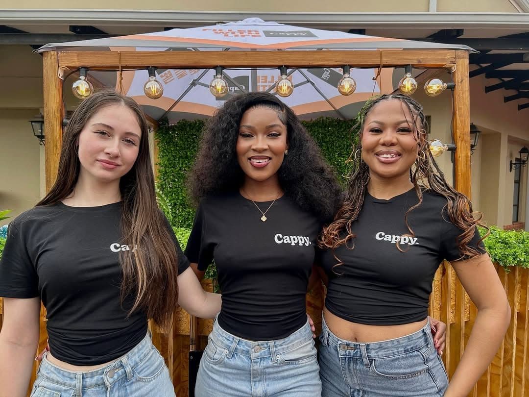Three Bluebell brand ambassadors in Cappy T-shirts at an activation